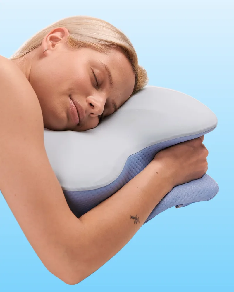 Woman hugging the butterfly-shaped pillow with her arm around it