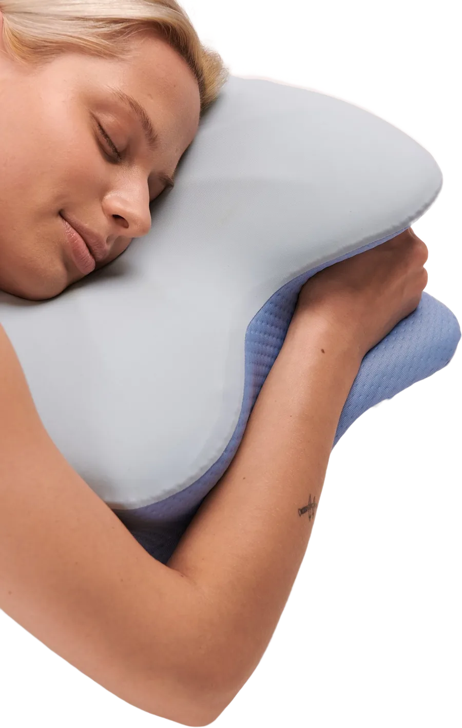 Woman asleep on her side, hugging a light-blue butterfly-shaped memory foam pillow
