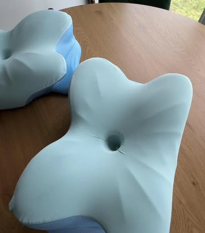 Top view of the butterfly-shaped pillow on a wooden table